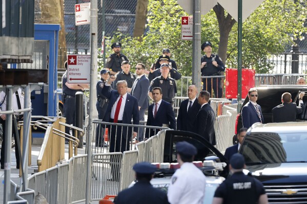 Former President Donald Trump arrives at Manhattan criminal court with his legal team, Monday, April 15, 2024, in New York. (AP Photo/Stefan Jeremiah)